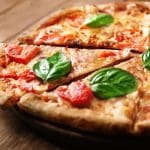A pizza with fresh basil