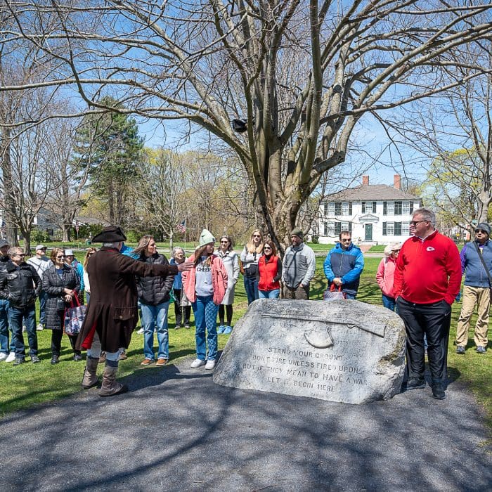 A tour guide giving a tour of the Lexington Battle Green