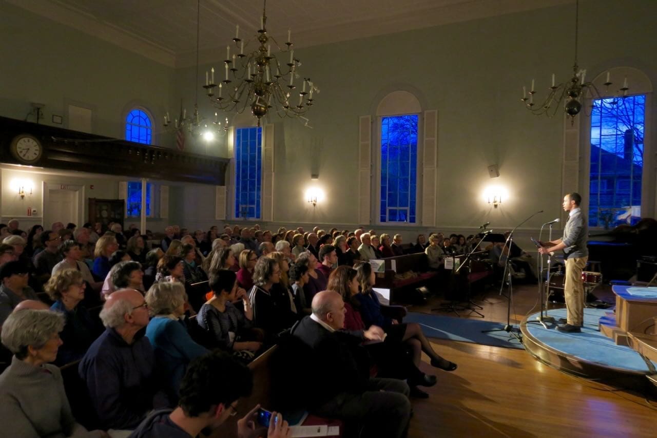 A group of people listening to a speaker