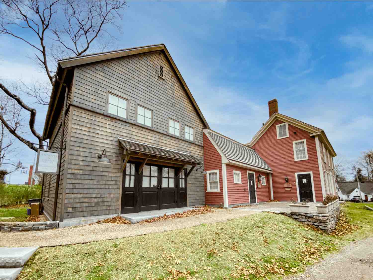 A barn and red house
